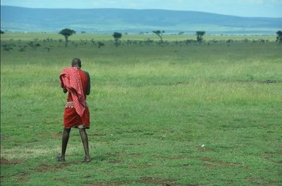 A member of the Masai tribe uses mobile technology In the Masai Mara National Reserve in Kenya, Africa.